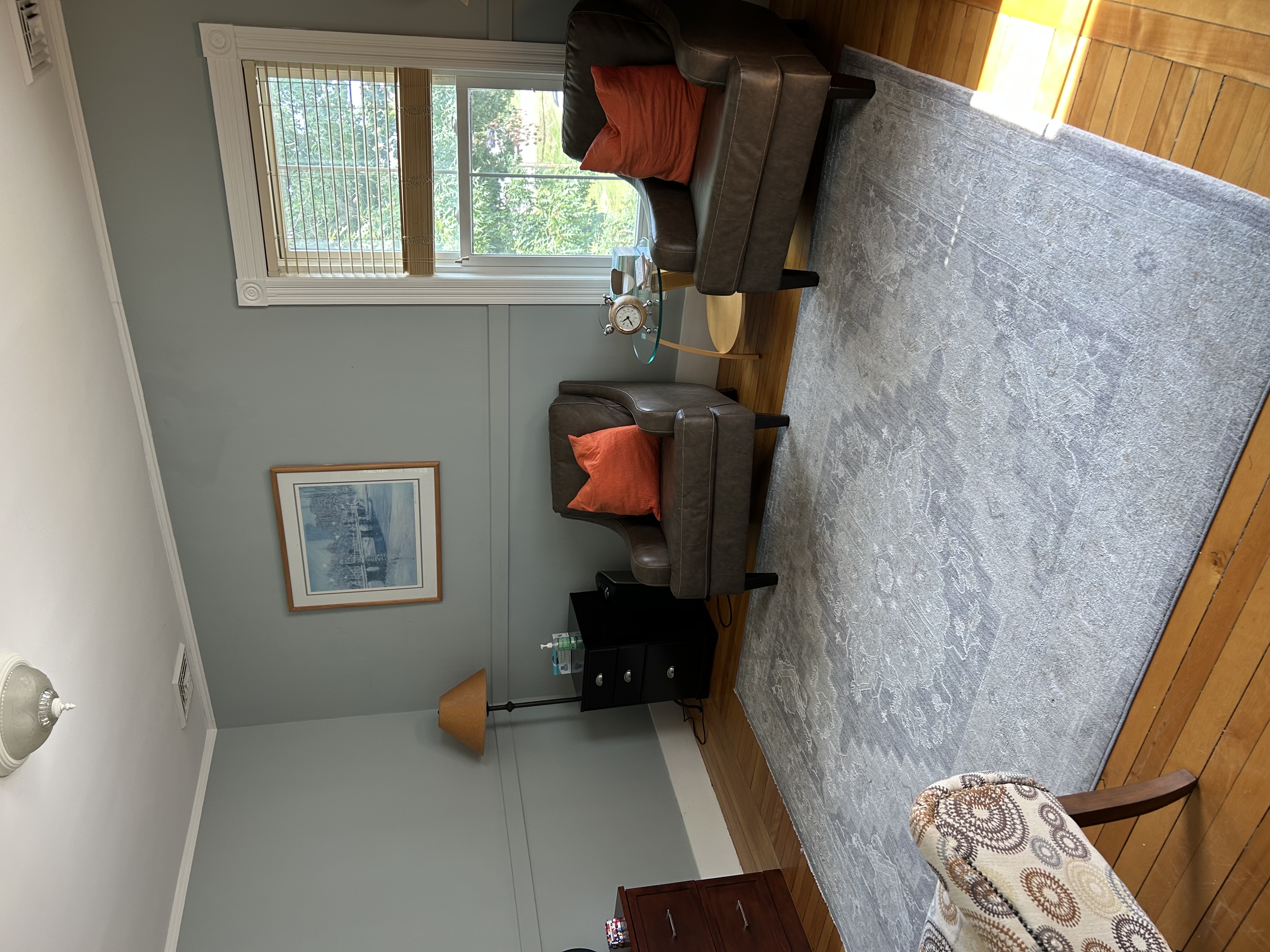 Stephanie's calm therapy office in Exeter with two armchairs
